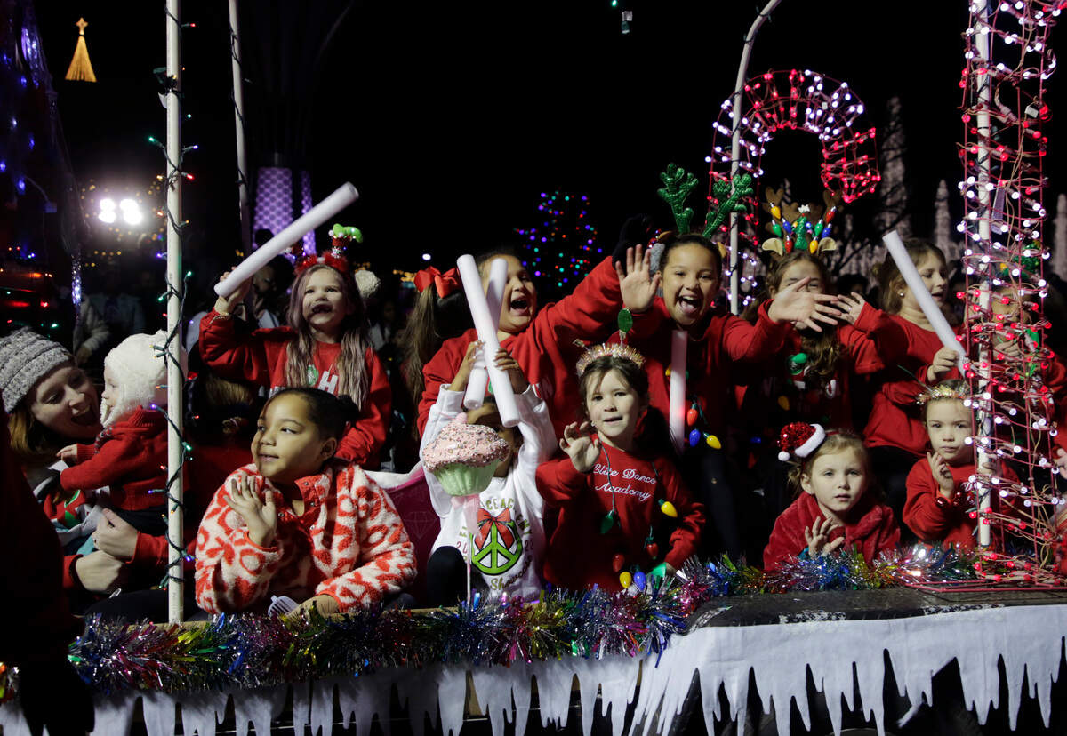 Children smile and wave on a float Friday at the Rock Hill Christmas parade.