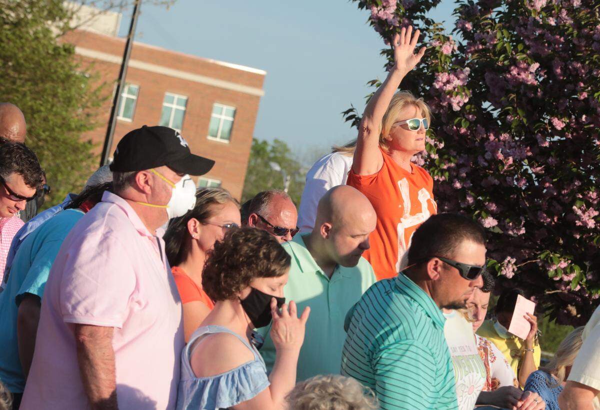 Mourners pray Sunday during a vigil to remember Robert and Barbara Lesslie, their grandchildren Adah and Noah Lesslie, all of Rock Hill; Robert Shook and James Lewis, both of Gastonia.