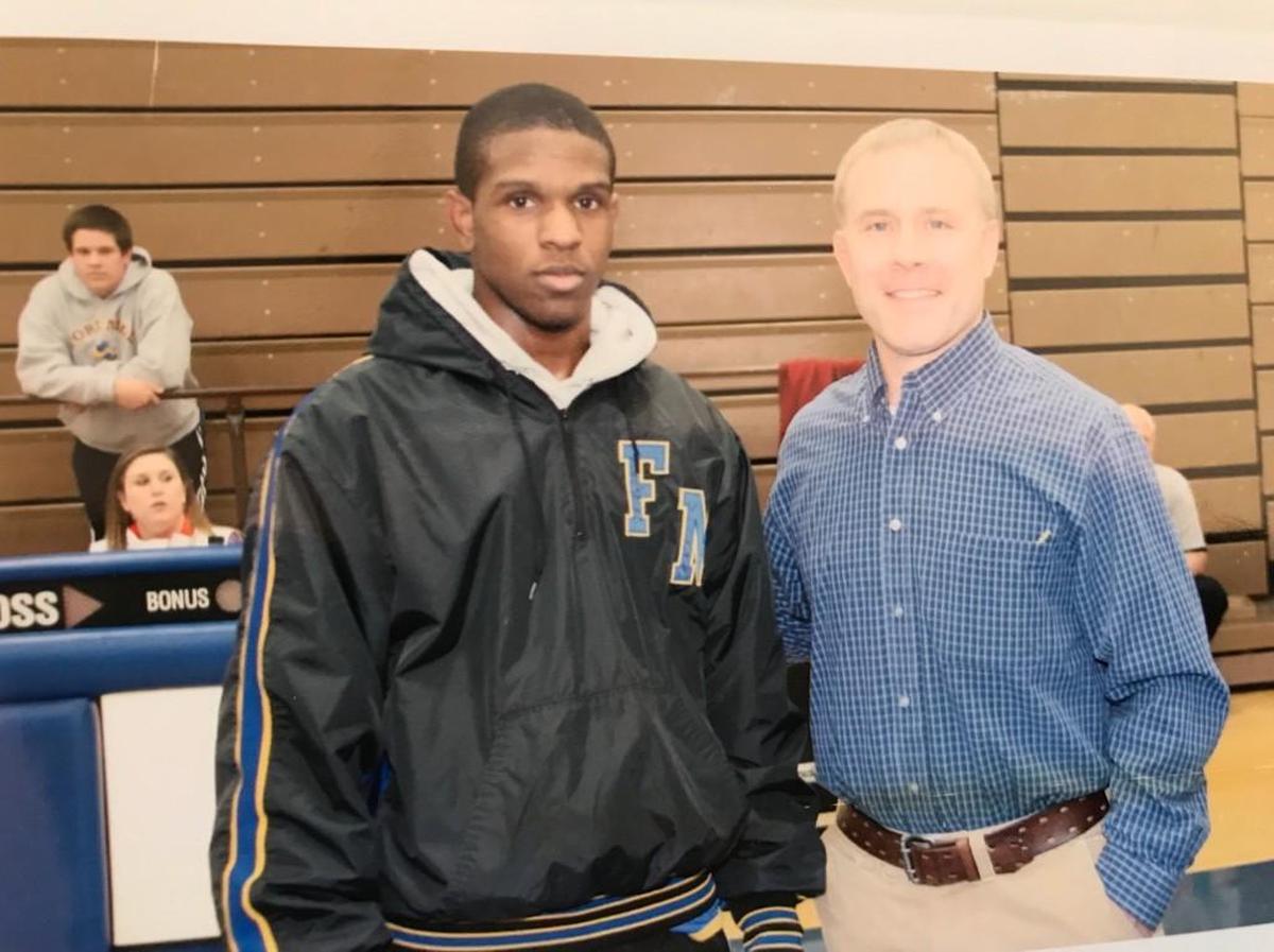 Jayvion “Jay” Sullivan, left, and Fort Mill High School wrestling coach Chris Brock in 2011. Sullivan, a 2011 graduate of the school and Army specialist, died in Iraq Monday.