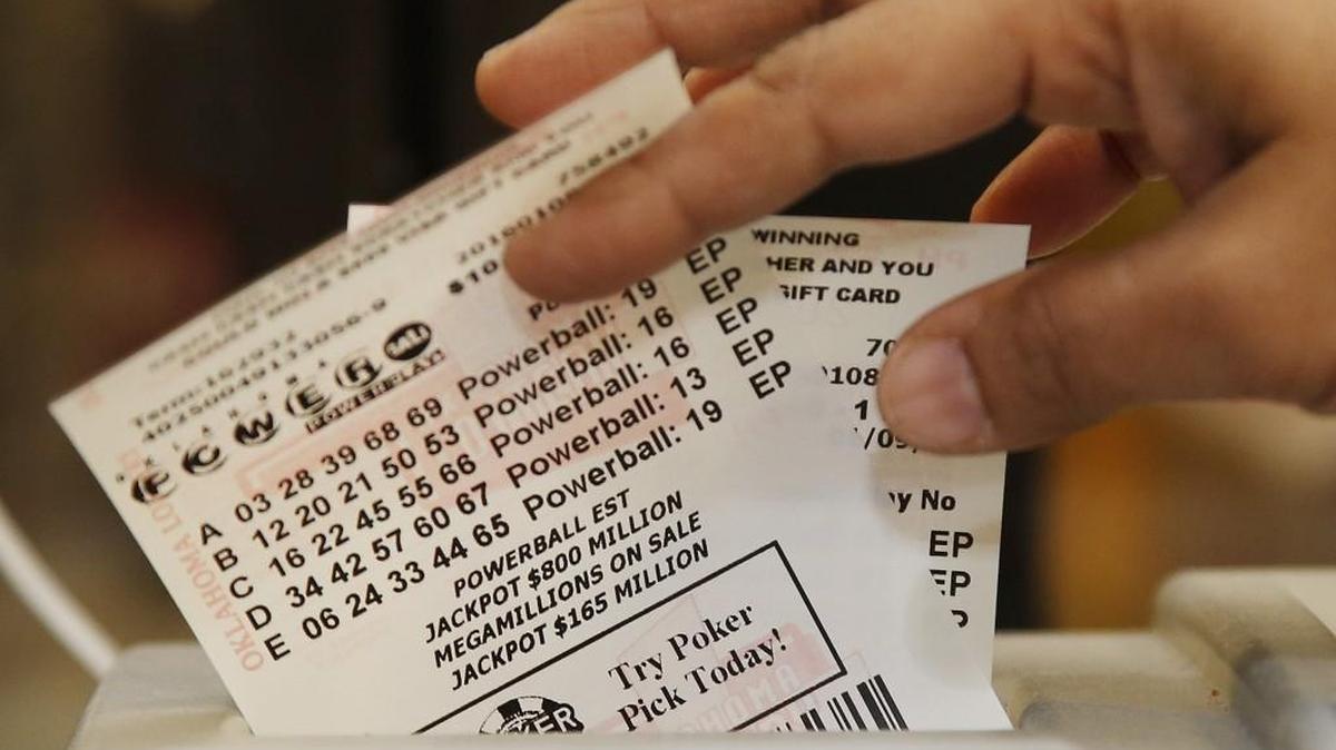 Momtaz Parvin pulls Powerball lottery tickets from the printer at her store in Oklahoma City, Friday, Jan. 8, 2016, as the multi-state jackpot reaches $800 million. With ticket sales doubling previous records, the odds are growing that someone will win Saturday’s record jackpot, but if no one wins the top prize, next week’s drawing is expected to soar past $1 billion.