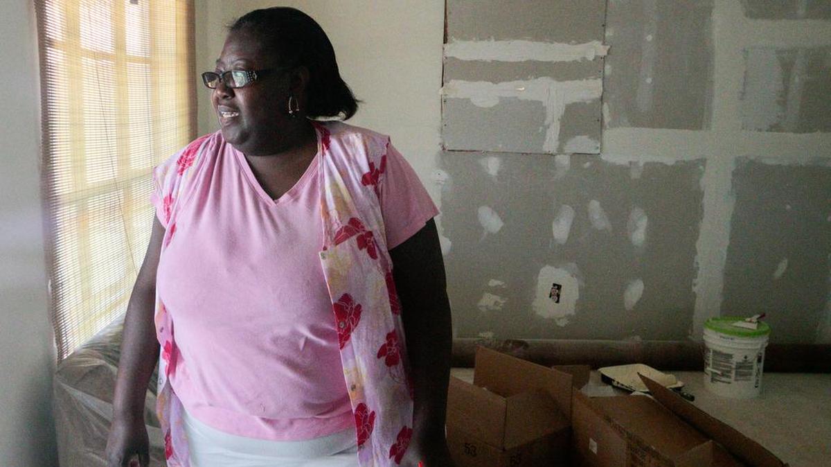 Melissa Wilson's house was half covered in floodwaters from the October flood. She is living in her house, which had to be gutted to the frame on the inside, while she is rebuilding as she can afford it .