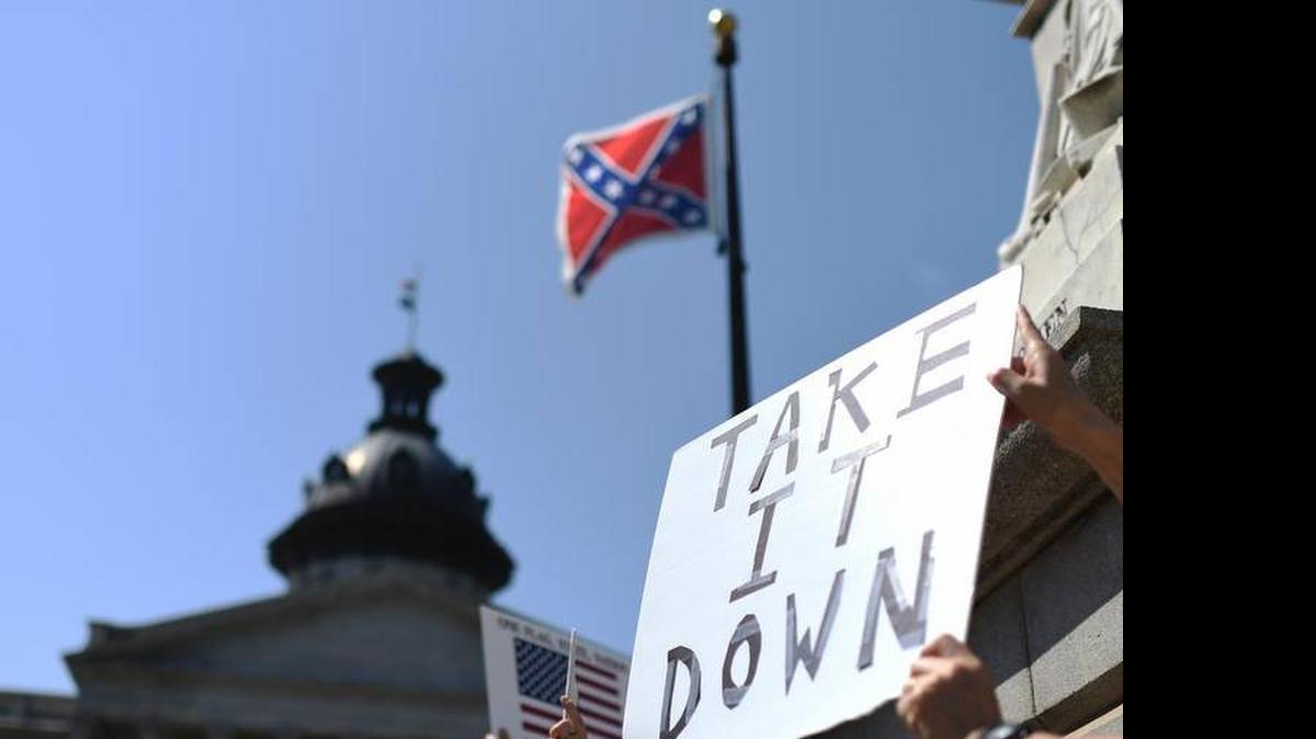 
Protestors call for the Confederate flag to be removed from the S.C. State House grounds. Legislators voted to furl the flag early Thursday morning.
