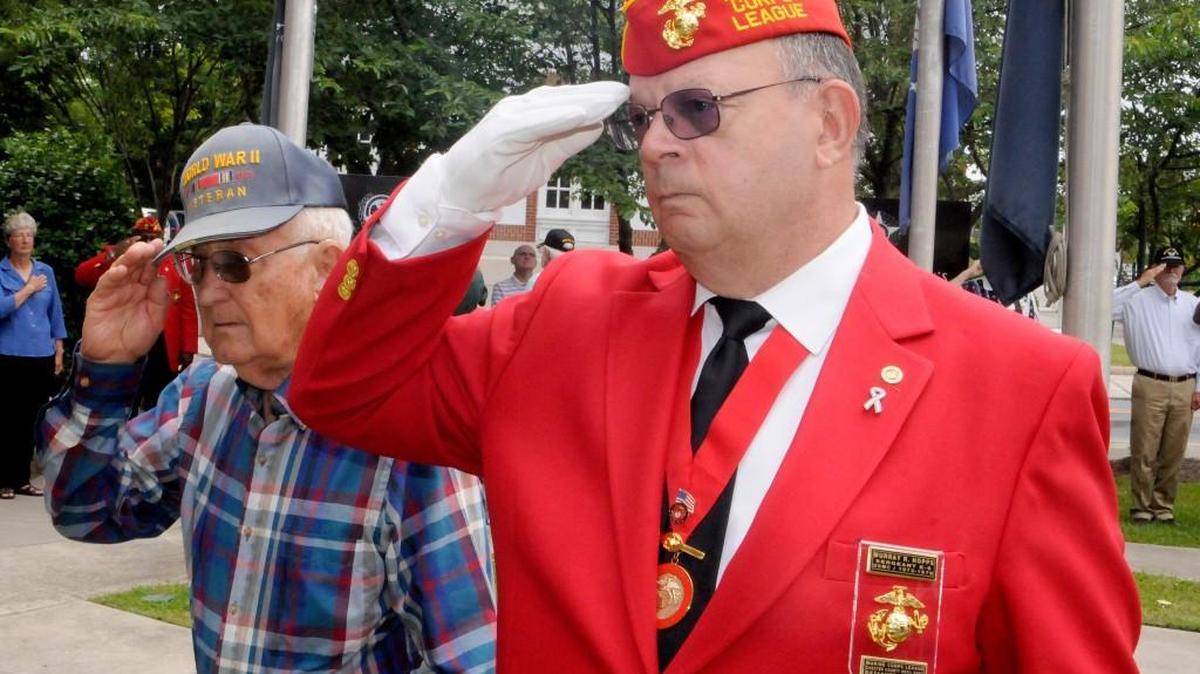 World War II veteran Gary Roberts, who served in the U.S. Army, left, and Vietnam-era veteran Murray Hopps, who served in the U.S. Marine Corps, salute as “Taps” is performed during a Memorial Day ceremony Monday in downtown Chester.