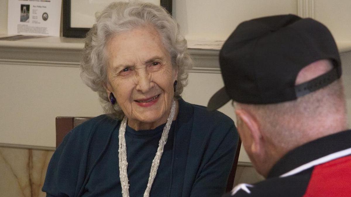 Mary Phillips White Gettys speaks with Harvey Mayhill of the Quilts of Valor Foundation in 2015. The Foundation, an organization that provides veterans and combat service members with a patriotic quilt, presented a handmade quilt to Gettys.