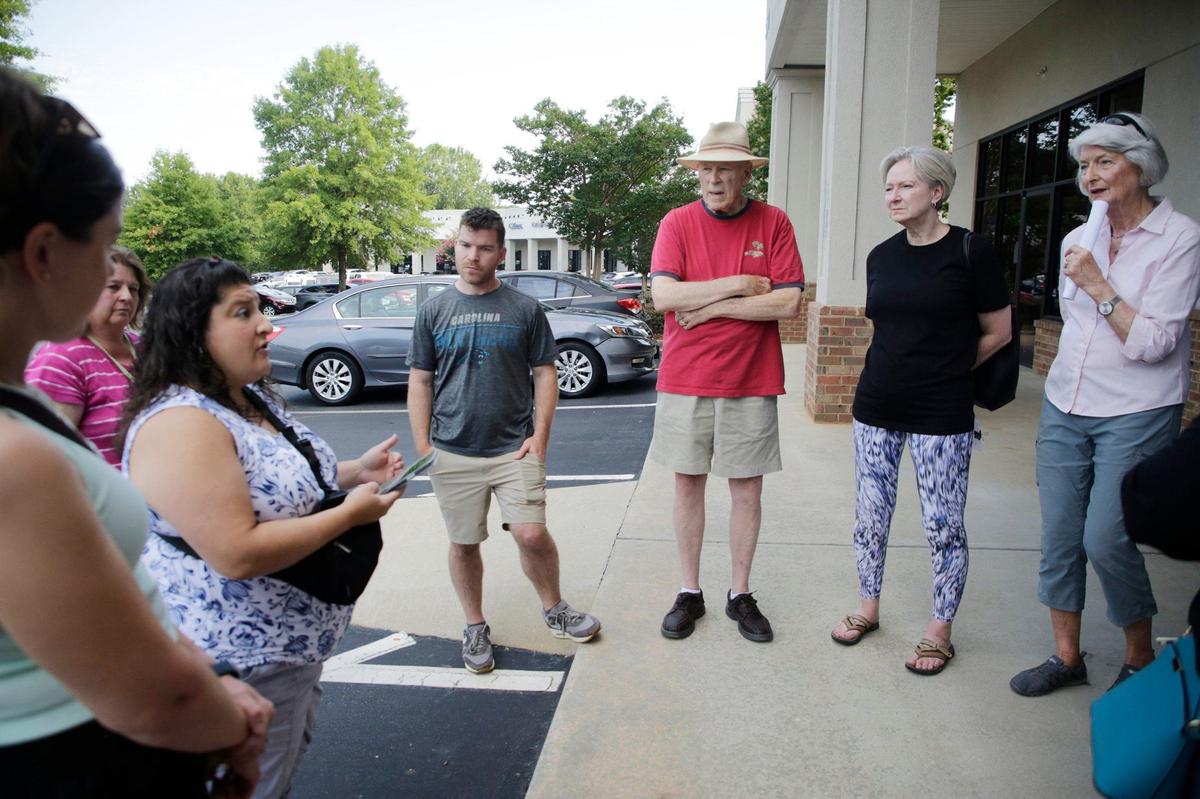 Neighbors against Silfab Solar plans to manufacture solar panels in Fort Mill gather in Regent Park on Thursday to pass out information to businesses. Protests will continue after York County issued a statement indicating the company will be allowed to operate near schools under construction.