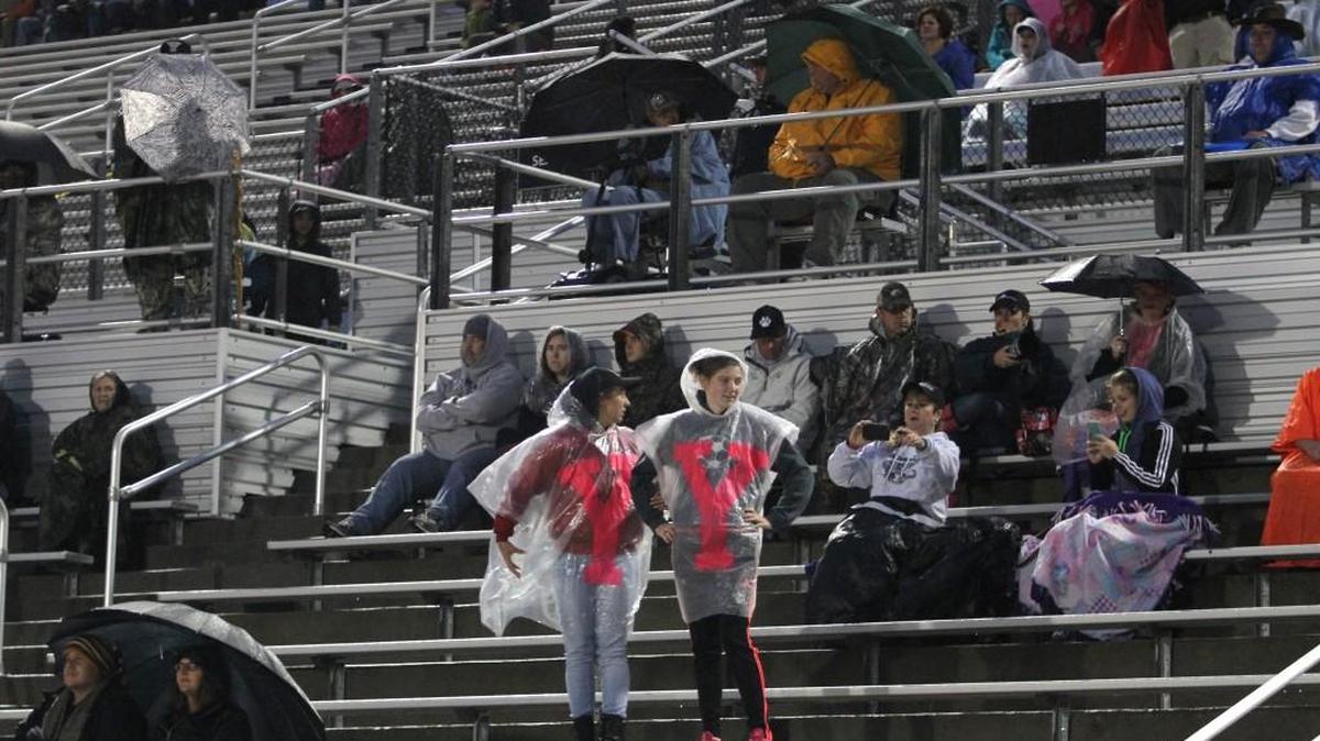  York fans endure wind and rain at the game against Northwestern Friday night in York.