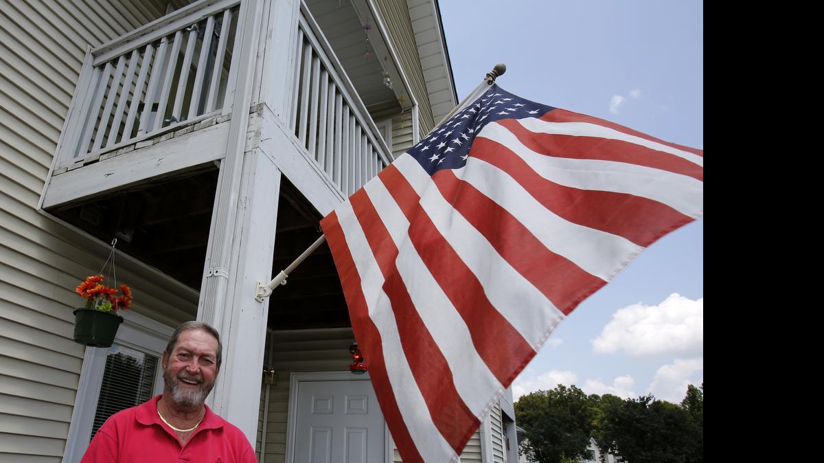 
Glenn Pettus with his American flag at Brittany Place Apartments in Rock Hill.
