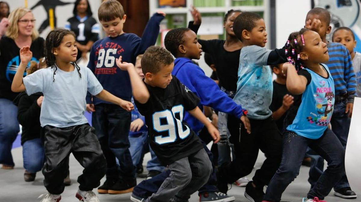 Students at the Chester Park Center of Literacy Through Technology show off their moves during a Carolina Panthers pep rally that also paid tribute to their fallen hero, La’Darious Wylie.