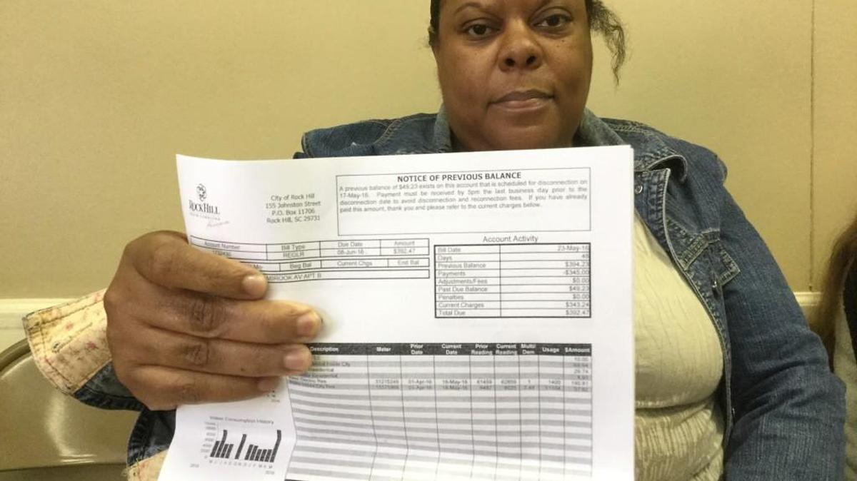 Janet Brice of Rock Hill holds her utility bill of $392.47. She went to Carolina Community Actions on Thursday to try to avoid disconnection Friday.
