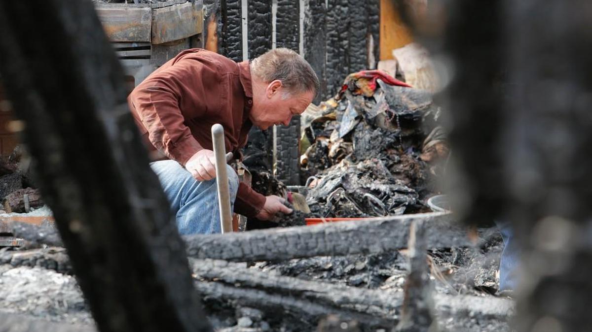 Randy Jowers searches through the ashes Tuesday for personal belongings after losing his home to a fire last weekend.