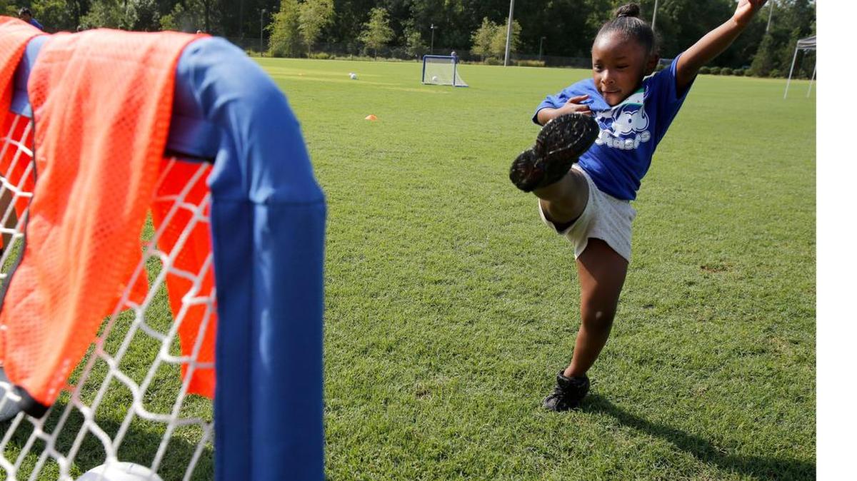 
A group of teens set up and ran a soccer camp for 25 youngsters ages 5 to 8 from the Rock Hill Boys and Girls Club. Three days of fun, big brothering and big sistering, and life lessons that were more than soccer. The camp was held at the Manchester Meadows soccer complex. Camper Alana Taylor, 6, kicks one in the goal.
