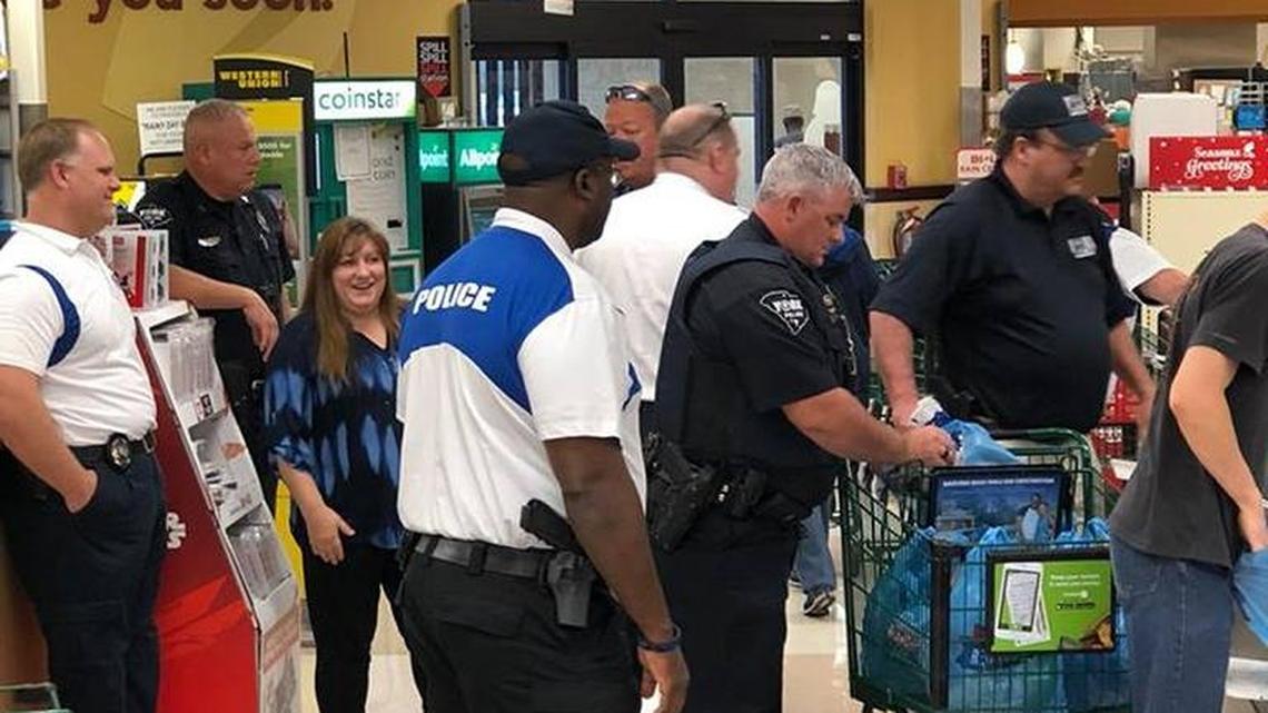 Paper, plastic and badges. York police bag groceries to brighten kids’ Christmas