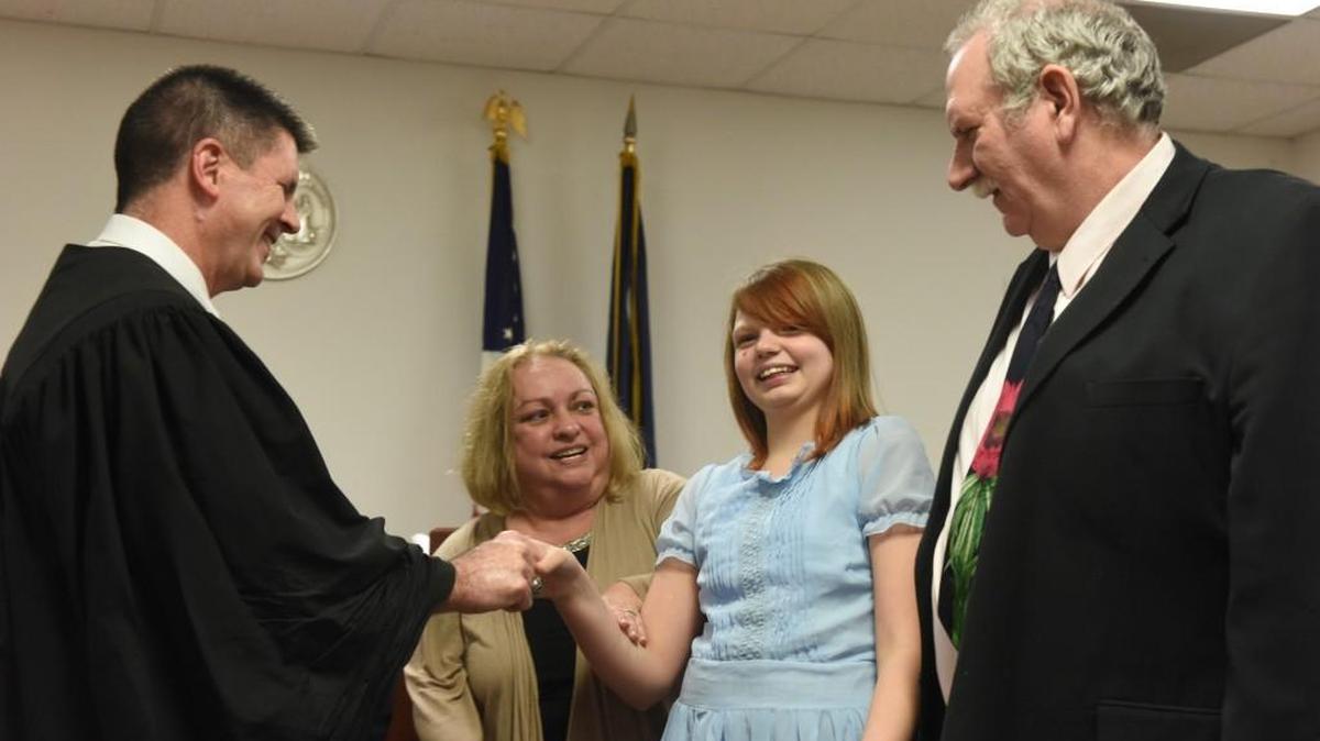 Family Court Judge David Guyton congratulates Robin and Phillip Yontz and their daughter, Aryka, after the finalization of Aryka’s adoption proceedings on Tuesday.