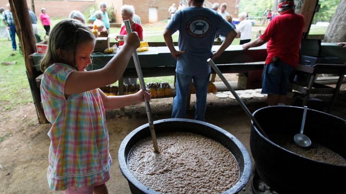 Savannah Howell, 9 at the time, stirs hash for the 95th annual Hopewell Day. Her great grandfather Horace Howell stirred hash at the event for years. The 100th Hopewell Day this Wednesday might be the last time the event is held in the middle of the week.
