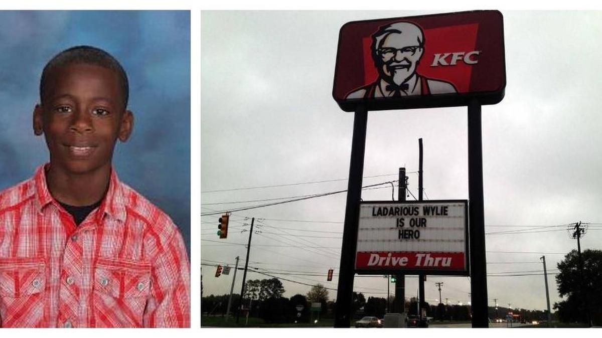 The sign at KFC honors La’Darious Wylie, who saved his sister at the bus stop near his home in Chester.