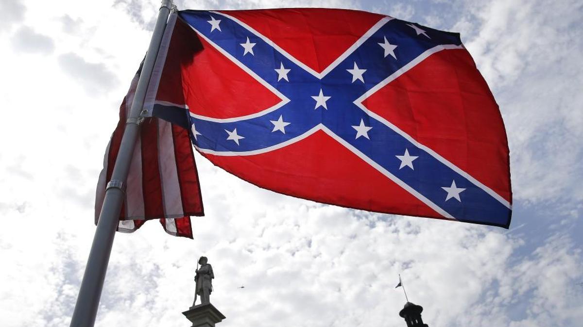 A protester waves a Confederate flag in front of the South Carolina statehouse in this 2015 file photo. York Technical College has a contract to host a convetion with the Sons of Confederate Veterans, which supports the flag.