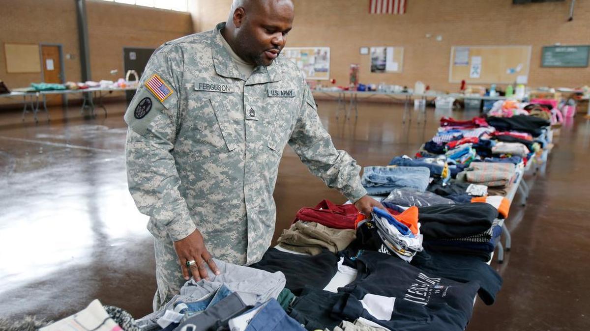 
Sgt. 1st Class Charles Ferguson looks over items collected by soldiers of the Army National Guard’s 178th Combat Engineer Battalion and their families for a big yard sale this weekend to raise money for an emergency fund. Ferguson was helped when his house burned down a couple of years ago and knows the real value of sticking together as a unit.
