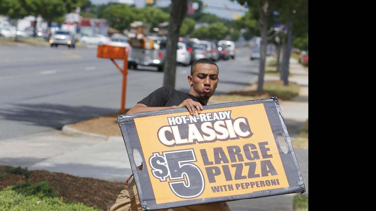 
Justin White of Rock Hill will compete Wednesday in the Little Caesars Shaker Board Contest in Las Vegas. He is shown Monday on North Cherry Road in front of the Rock Hill Little Caesars Pizza Restaurant.
