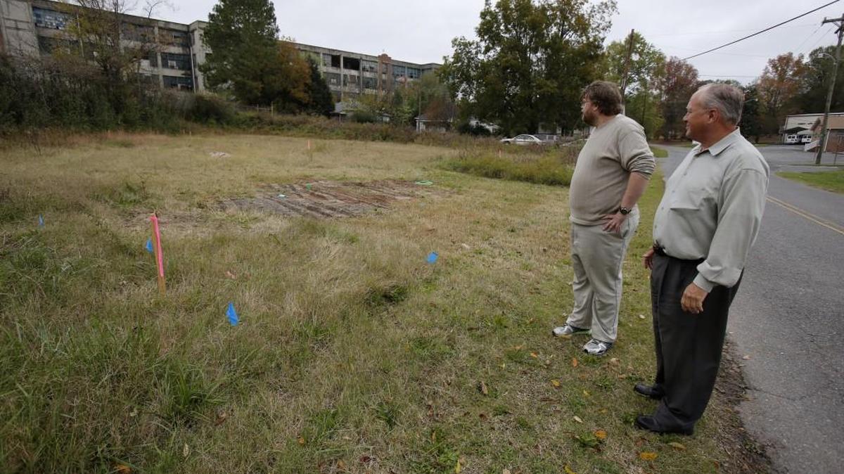 Neighbors and at at least one town councilman in Clover are upset over a 180-foot cell tower that will be built near houses. Neighbor Ed Dees Jr. left, and town councilman Todd Blanton look over the site for the cell tower on Walnut Street.