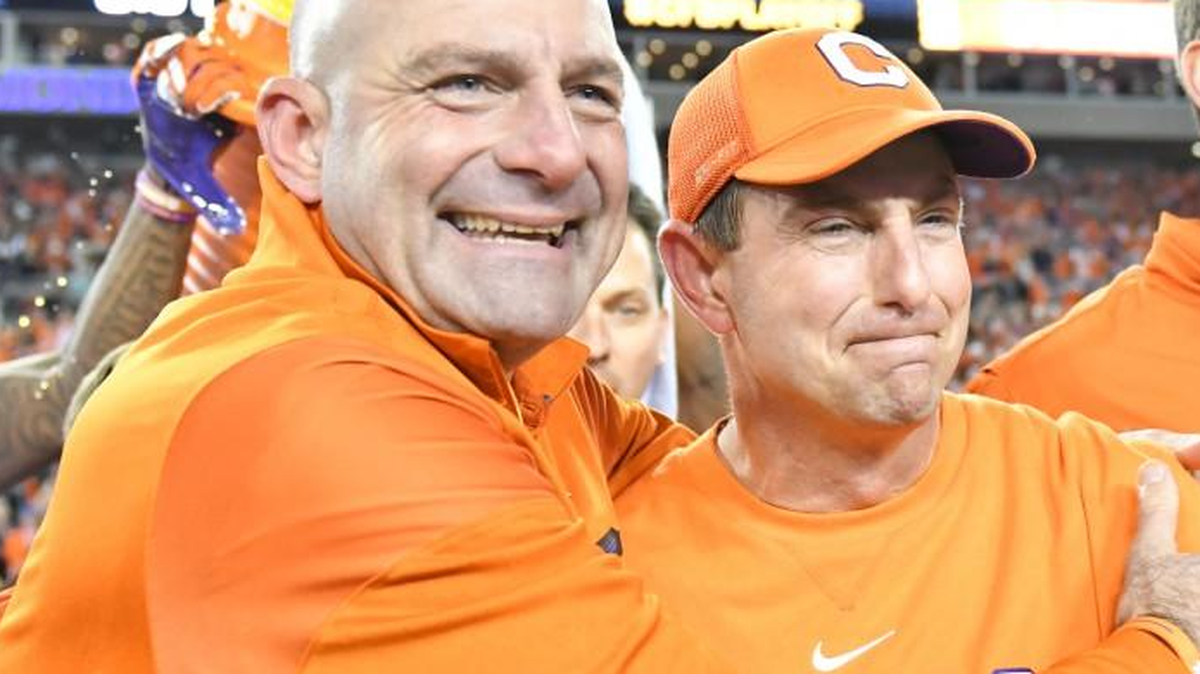 Tracy Swinney, left, head of security for the Clemson football team, with his brother, head coach Dabo Swinney. The brothers teamed up to send signed footballs from Clemson to the brother of one of the officers who died and an officer who was injured in a January incident between a domestic violence suspect and police where four officers were shot.