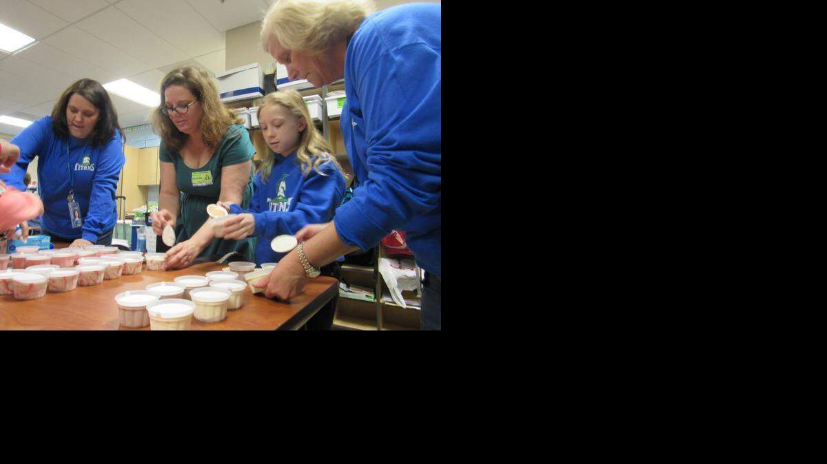 
Lucy Rosenberg, 8, her mother, Julie, and staff prepare to give second graders at Tega Cay Elementary School a treat on Ice Cream for Breakfast Day. Lucy’s father, Bruce Rosenberg, who died from cancer three years ago, started an annual March 21 Eat Ice Cream for Breakfast Day that has gone worldwide.
