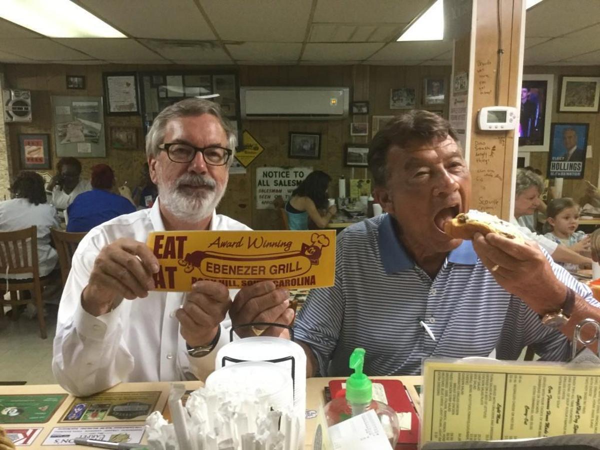 In this 2016 Herald file photo, Byron Caulk, right, on a quest for the best hot dog in the Carolinas, bites into the world famous hot dog at Rock Hill’s Ebenezer Grill, owned by Loyd Ardrey, left.