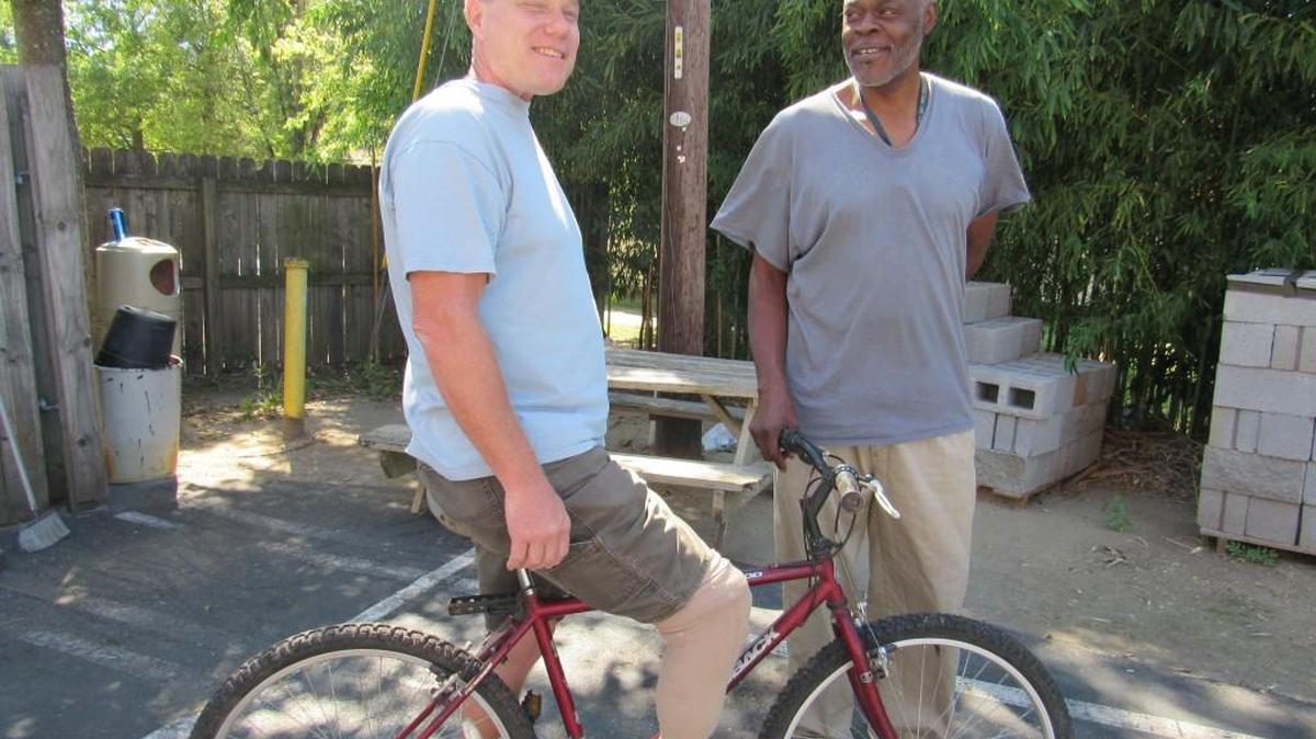 
James Blanks, 52, left, and his friend and neighbor Tony Simpson. Blanks who has a prosthetic leg and is voiceless, borrowed a bicycle after his was stolen in Rock Hill when he was at a charity getting food.
