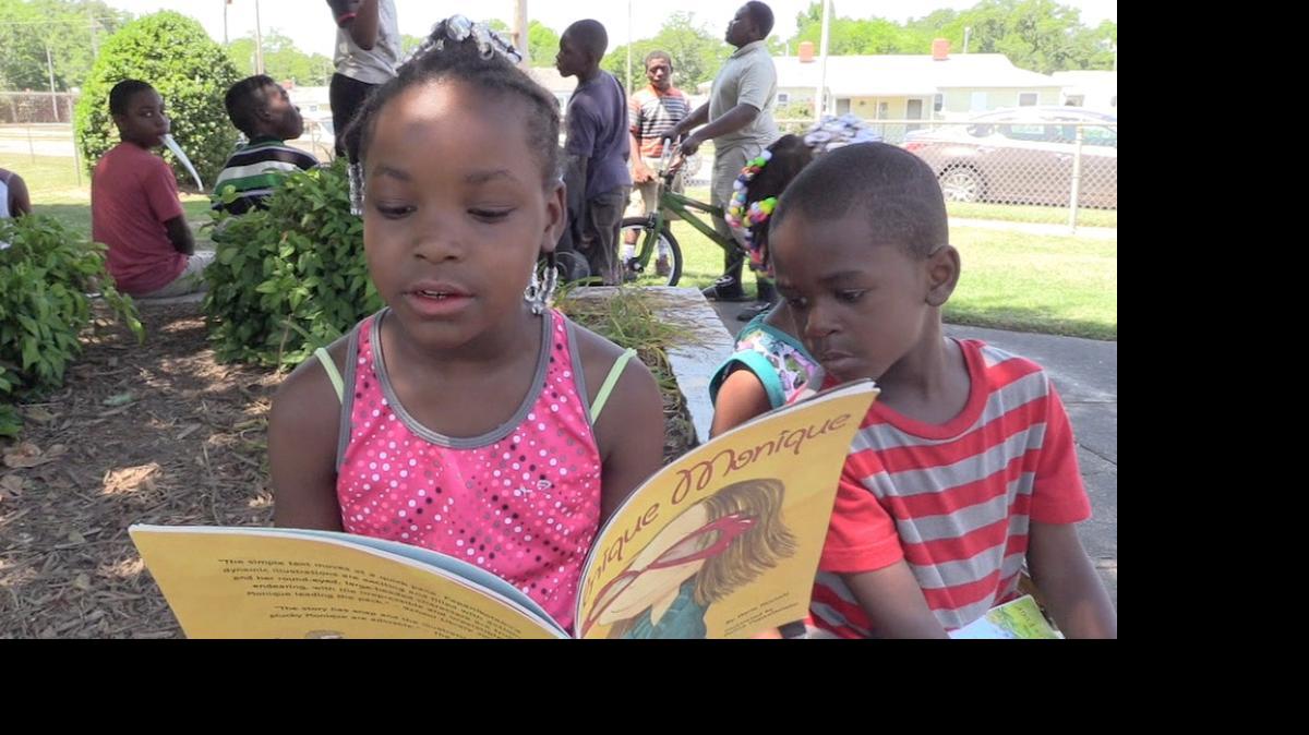 
Ciara Randolph, 8, reads a book given to her Wednesday from Ebinport Elementary staff.
