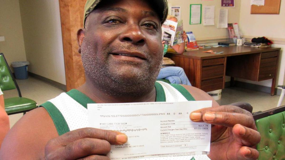 
Paul Roberts of Hickory Grove, disabled, shows his electricity bill that jumped with extreme summer heat in the last three months.
