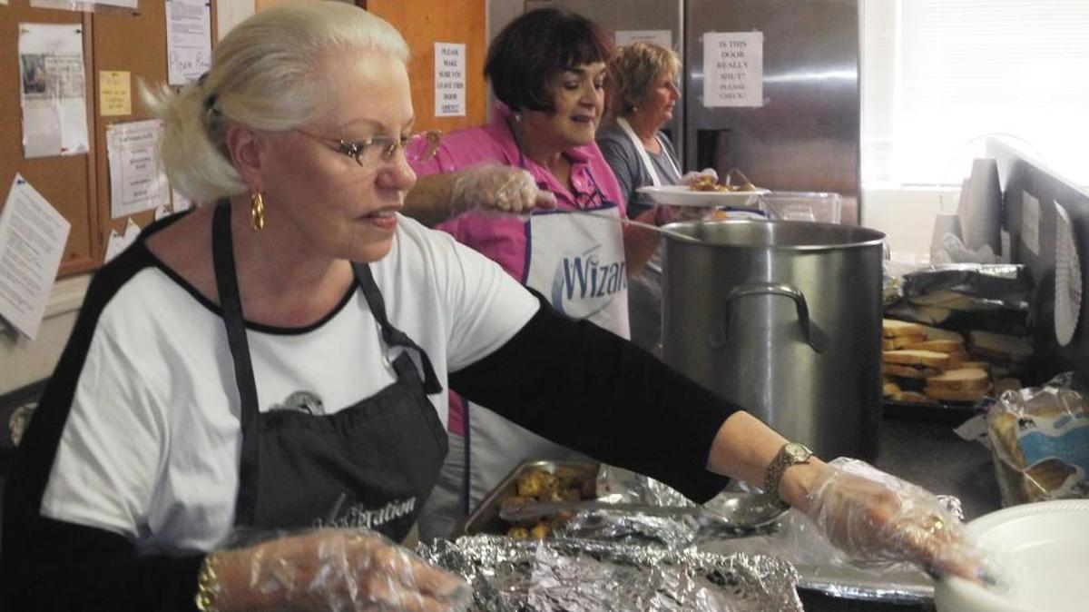 
Volunteers, from left, Lynné Carrouth, Mary Long and Diane Lamantia serve food they cooked Wednesday at Rock Hill’s Dorothy Day Soup Kitchen.

