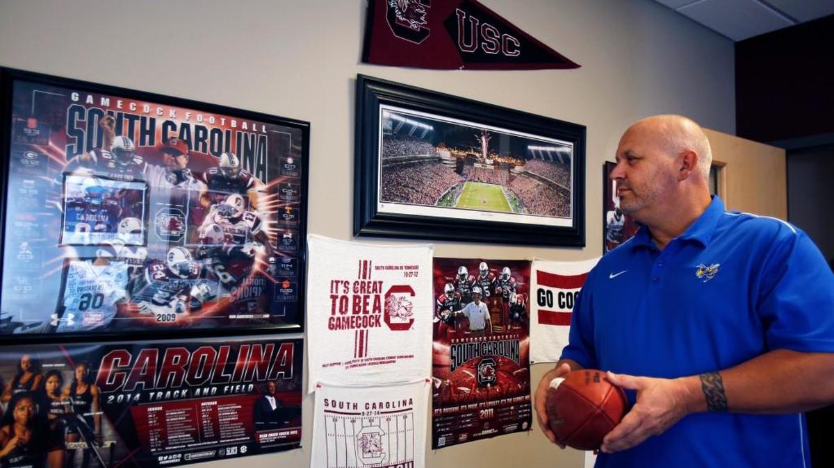 
Dana Ballard shows his Coach Spurrier and USC memorabilia in his Fort Mill office.
