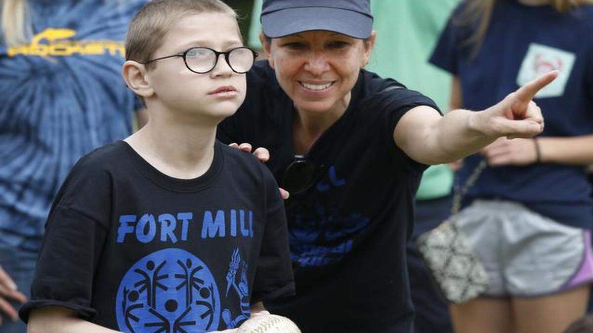 
The Area 11 Special Olympics at Cherry Park in Rock Hill on Friday. Dylan Bolles-Prasse, 9, who is deaf, gets instructions from his interpreter Amy Kiser while competing in the softball throw. He is a student at Riverview Elementary in Fort Mill.
