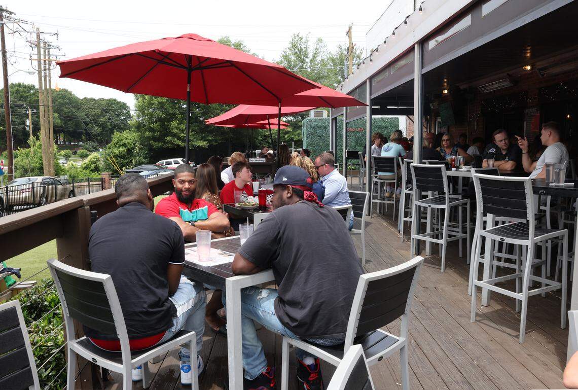 Diners pack the patio at Hobo’s in downtown Fort Mill Friday. Main Street has grown from many boarded shops to a thriving business area in the past 20 years.