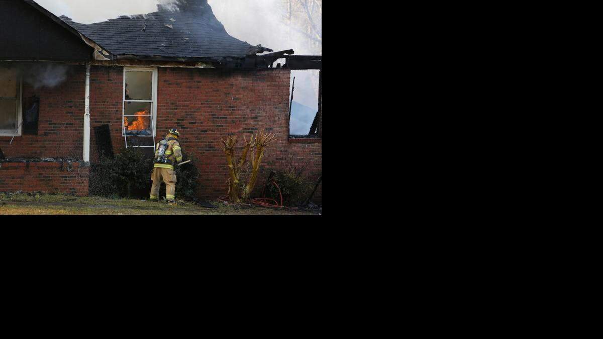 
A firefighter works to control the blaze at a home in Rock Hill on March 23. 

