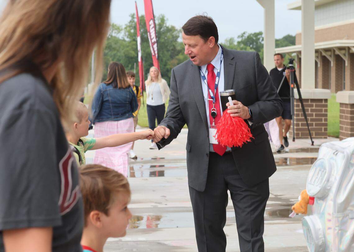 Grey Young, superintendent of the Fort Mill School District, does a fist bump with a student Monday, Aug. 4, 2025 at Flint Hill Elementary School. Monday was the first day open for Flint Hill, and the first school year as superintendent for Young. Next year, the district will allow students who live outside the area attend, if their parents are district employees.