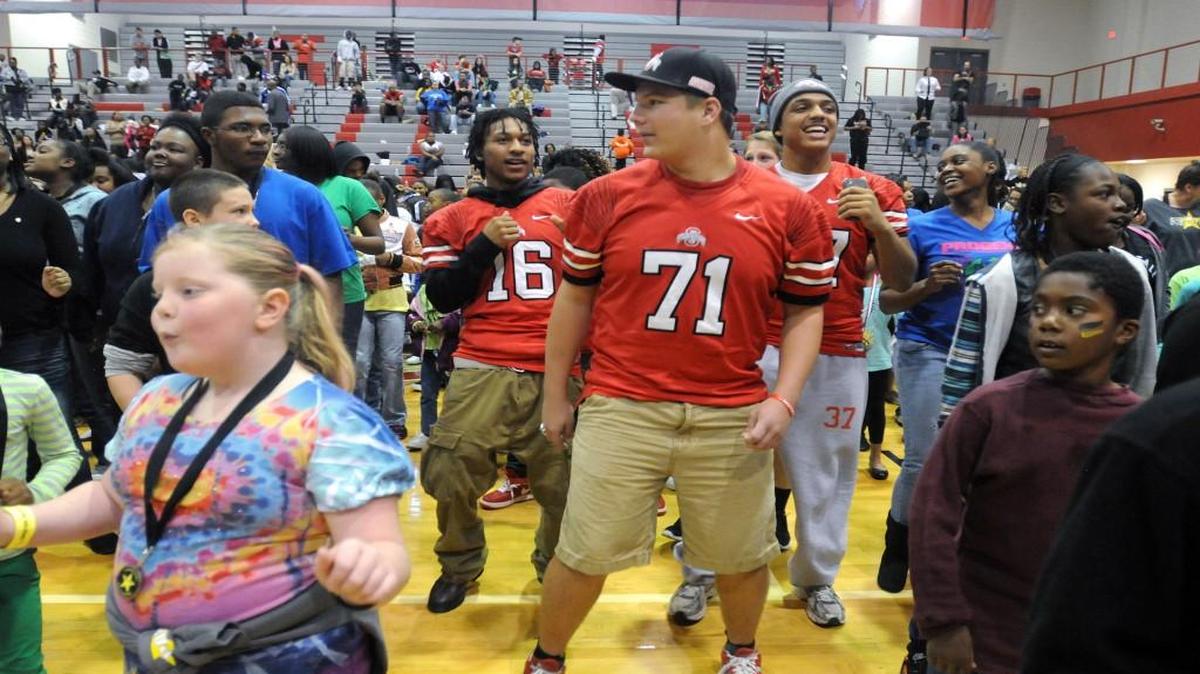 South Pointe High School football players shown in 2015 doing the Cupid Shuffle with other children during the Cheer For Children event.
