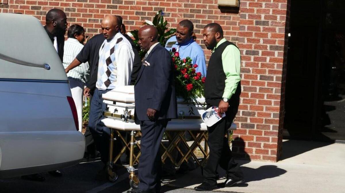 From left to right: Clifford Massey, Kenneth Walton, Bernard Cunningham and Otay Parks place the casket of 3-year-old Sa’Vion Barrow into a hearse after Saturday’s memorial service. The toddler died Nov. 15 after accidentally shooting himself with a gun in his family’s home.