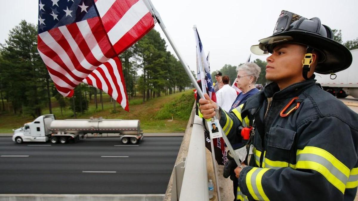 
Flag wavers on the Leonard Farrington Bridge over I-77 in Fort Mill Friday morning to remember the attacks of 9/11. Rock Hill Fire Department firefighter Fernando Diaz, right, and Betty Farrington, wife of the late Leonard Farrington, wave flags from the bridge. Diaz will participate in the Duke Energy stair climb in Charlotte Saturday and the New York City Marathon in November. Leonard Farrington started the tradition of flag waving from the Sutton Road bridge on 9/11 as a reaction to the attacks.
