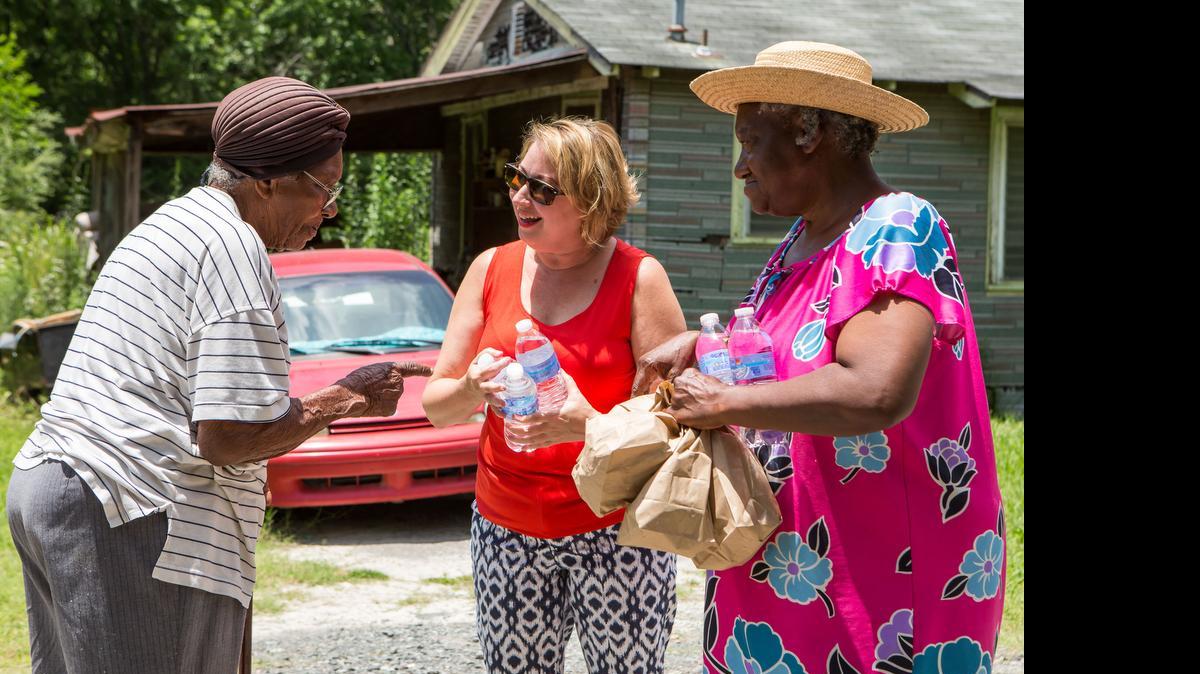 
Jane West with the social ministry of Lake Wylie Lutheran Church delivers free lunches to 95 year old Hope Whitlock (L) and her daughter Eva May Whitlock (R) in the Blackmon Road area of Rock Hill. 6-14-2015.
