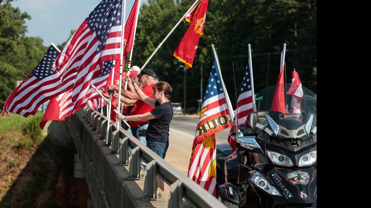 
York County veterans and family members wave flags to honor four slain Chattanooga Marines on the Sutton Road overpass on Friday.
