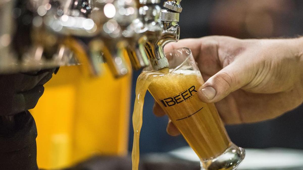 A vendor pours a beer at Saturday’s World Beer Festival, a fun way for people to explore different brews and, perhaps, develop new favorites.