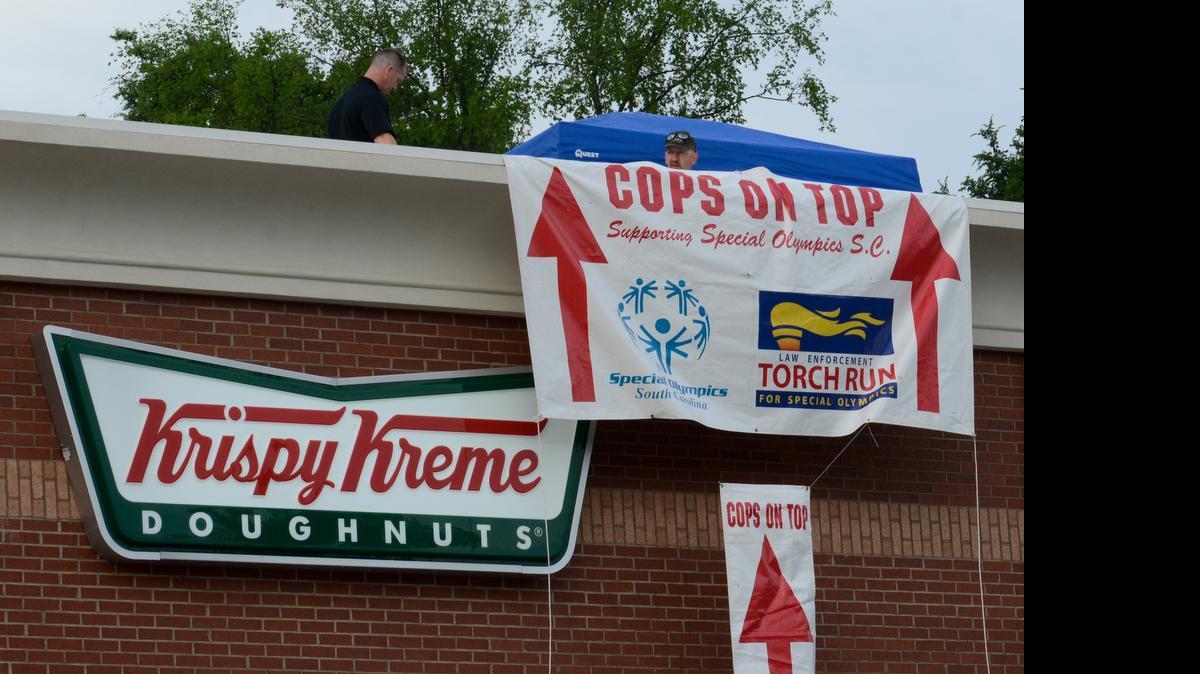 
Glenn Williams and Carson Neely of the York County Sheriff's Office take the first shift on the roof during the Cops On Top fundraiser at Krispy Kreme on Celanese Boulevard in 2014.
