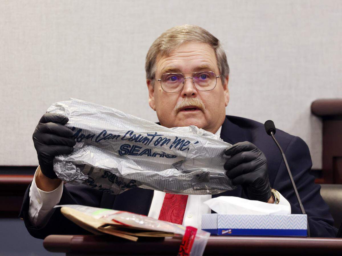Former York County Sheriff’s Office crime scene investigator John Williams holds up a Sears bag that contained the body of an infant that was found in the Catawba River in 1992.