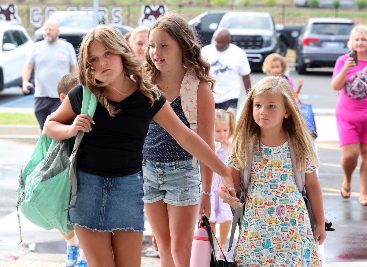 Flint Hill Elementary School students walk to the school on the first day Monday, Aug. 4, 2025 in Fort Mill, S.C. First-day traffic was fairly smooth Monday morning despite concerns last week after the district announced it wouldn’t have traffic guards from an outside company.