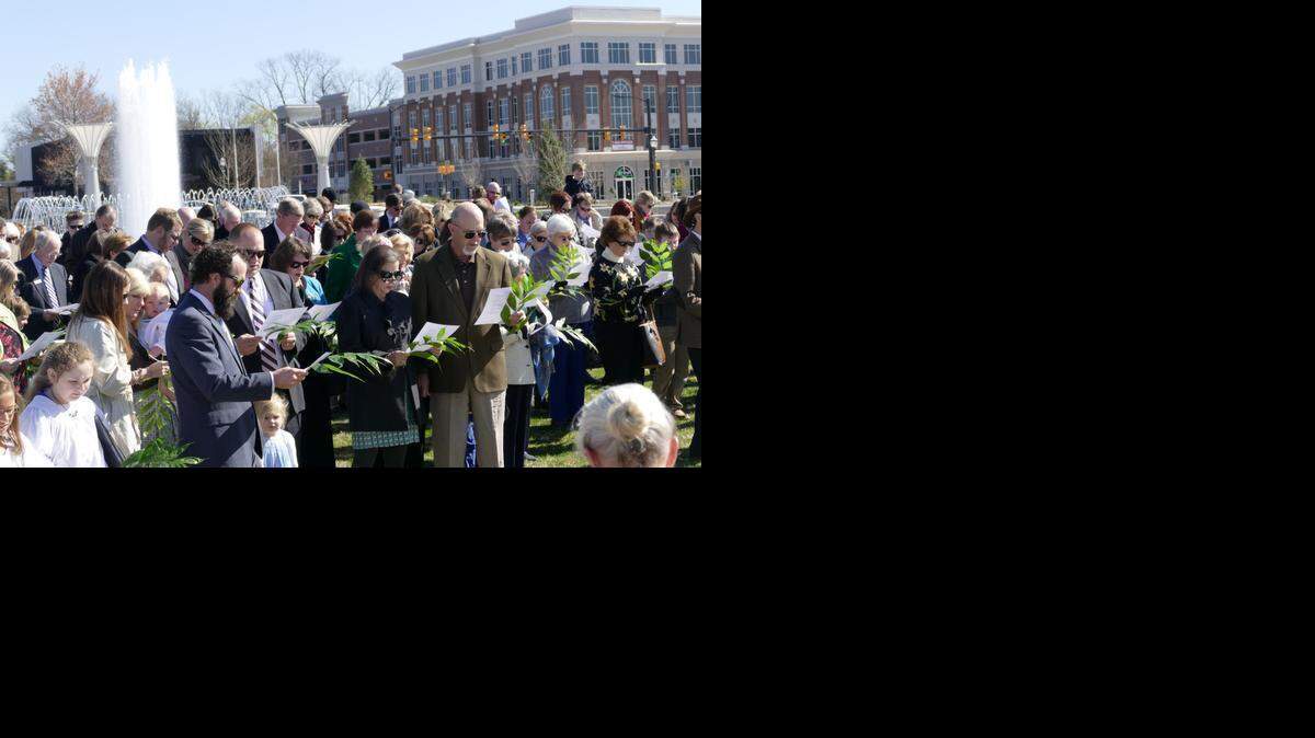 
Worshippers from Rock Hill’s First Presbyterian and St. John’s United Methodist churches, along with members of the public, attended a Palm Sunday service in Fountain Park on Sunday morning. The crowd sang a hymn and heard a Scripture reading before the Methodists and Presbyterians processed from the downtown park to their nearby churches.
