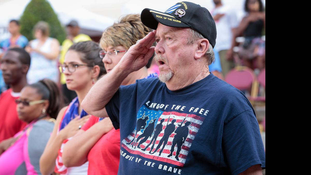 
U.S. Army Ret. Bill Stikeleather salutes and sings while the national anthem plays as Rock Hill hosts Red White and Boom on Friday.
