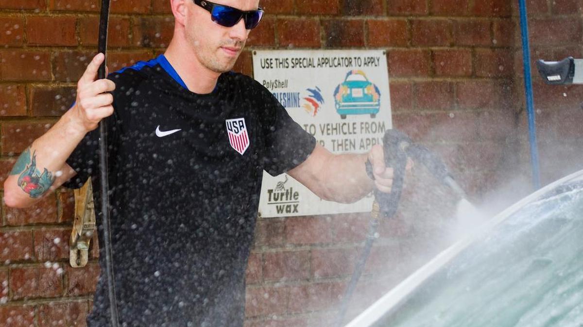 Tim Henderson of Rock Hill washes his car Friday at Gleam Works.