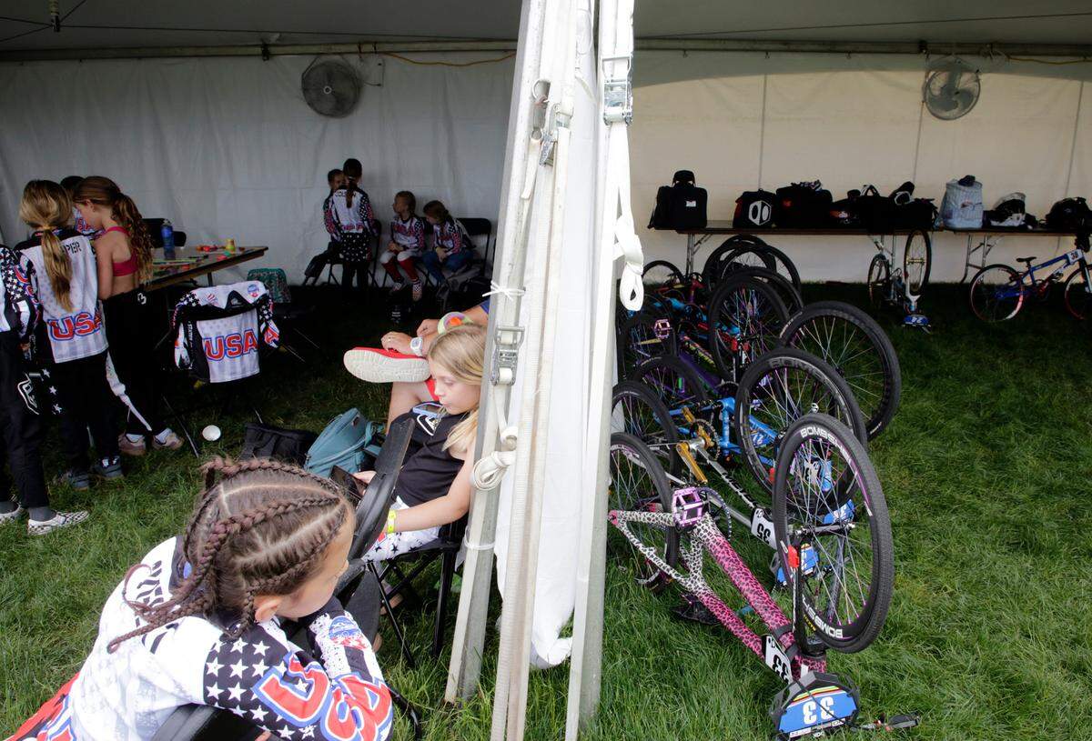 The 8-year-old girls at the BMX World Championships in Rock Hill relax and play before competing Monday.