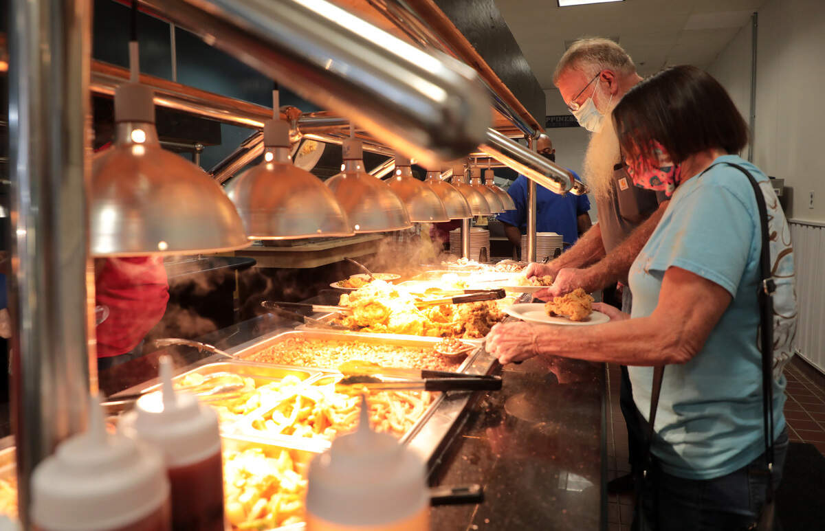 Customers at Big Boys Country Cooking in Rock Hill serve their plates Monday.