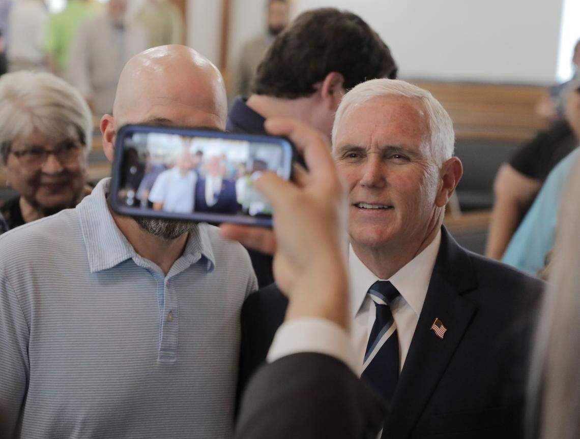 Former Vice President Mike Pence, right, poses for a photo at Lakewood Baptist Church where he was a guest speaker.